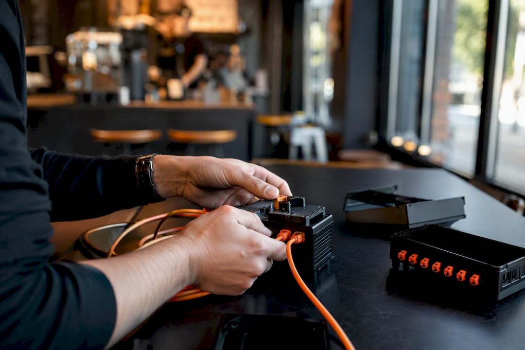Hands wiring server components in marketing tech setup