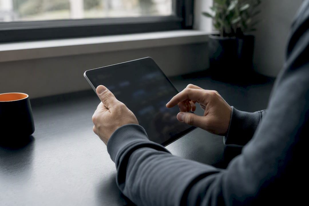 Hands holding smartphone with dark analytics screen